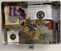 A quantity of military cap badges, medals etc