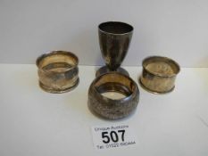 Three hall marked silver napkin rings and a hall marked silver egg cup.