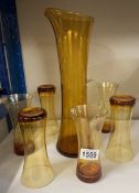 A vintage jug & 6 glasses, amber coloured