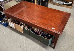 A large coffee table with drawers either end