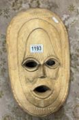 A carved wooden tribal mask