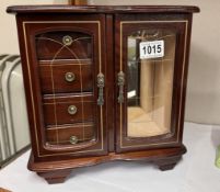 A two door jewellery cabinet.