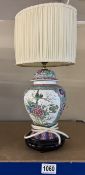 A Chinese style table lamp with shade.