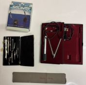 A slide rule, compass set, microphone with stand & headphones