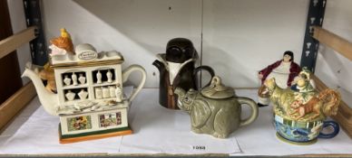 A quantity of decorative teapots including Carters Perfumery