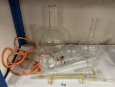 A selection of quick fit chemistry glassware including bottles