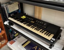 A boxed Yamaha electric organ with stand. (No power supply) Model PSR-82
