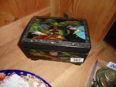 An oriental lacquered jewellery box.