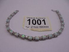An opal and diamond white metal bracelet, (no fastening).