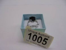 A large black stone diamond ring with diamond shoulders, size N half, 3 grams.