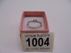 A yellow gold three stone diamond ring, 80pt. size R half, 1.75 grams.