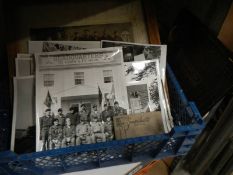 A tray of old black and white photographs.