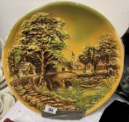 A large plaster wall plaque and a ceramic Dutch house tile plaque.