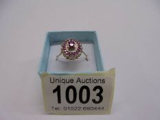 A 9ct gold ring set ruby surrounded by diamonds, size T, 2.1 grams.