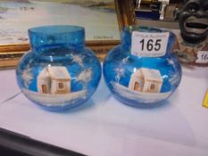A pretty pair of Mary Gregory style blue glass vases decorated with a snow scene. 8.5 cm tall.