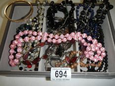 A mixed lot of necklaces etc.,