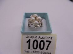 A yellow gold diamond and pearl ring, size M, 4.5 grams.