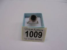 A large oval sapphire and diamond ring set in yellow gold, size Q, 5.4 grams.