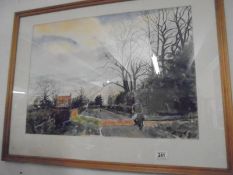A large framed and glazed watercolour featuring a cyclist on a country road, signed but indistinct.