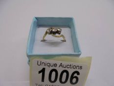 A yellow gold Edwardian three stone crossover ring, 40pt. size M, 2017 grams.