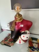 A light in the form of a woman's bust, featuring card symbol decoration