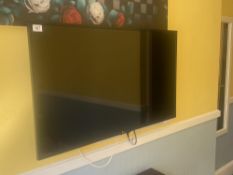 An LG TV measuring 22 inches high and 38 inches wide
