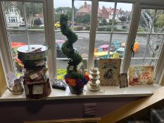 A collection of Alice in Wonderland-themed items, including a small Cheshire cat, a card display,