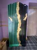 A pained green and black stripe wardrobe with black and gold decoration