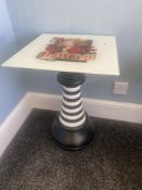 A Hatter's bedside table featuring the Queen of Hearts