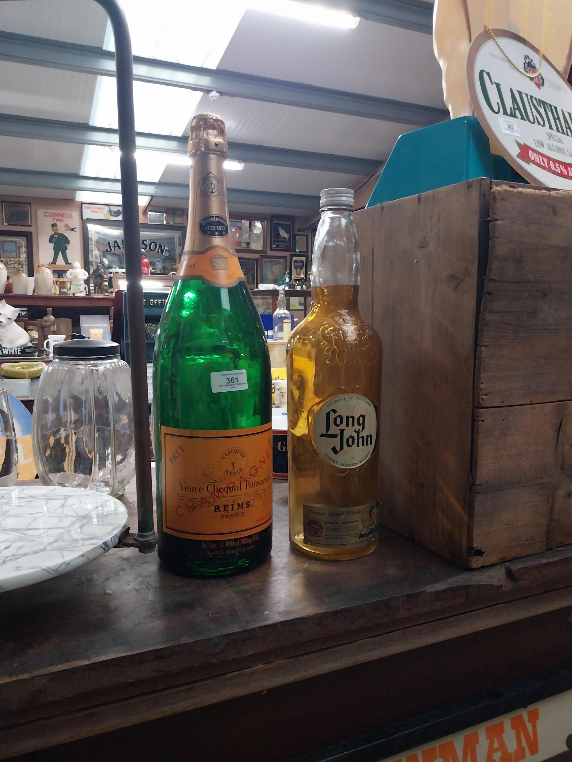 Long John Whiskey bottle and Veuve Clicquot champagne bottle. {50 cm H x 12 cm Dia} and {42 cm H x