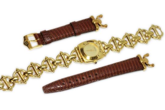 A ladies gold plated Gucci wristwatch with spare leather and gold plated strap.