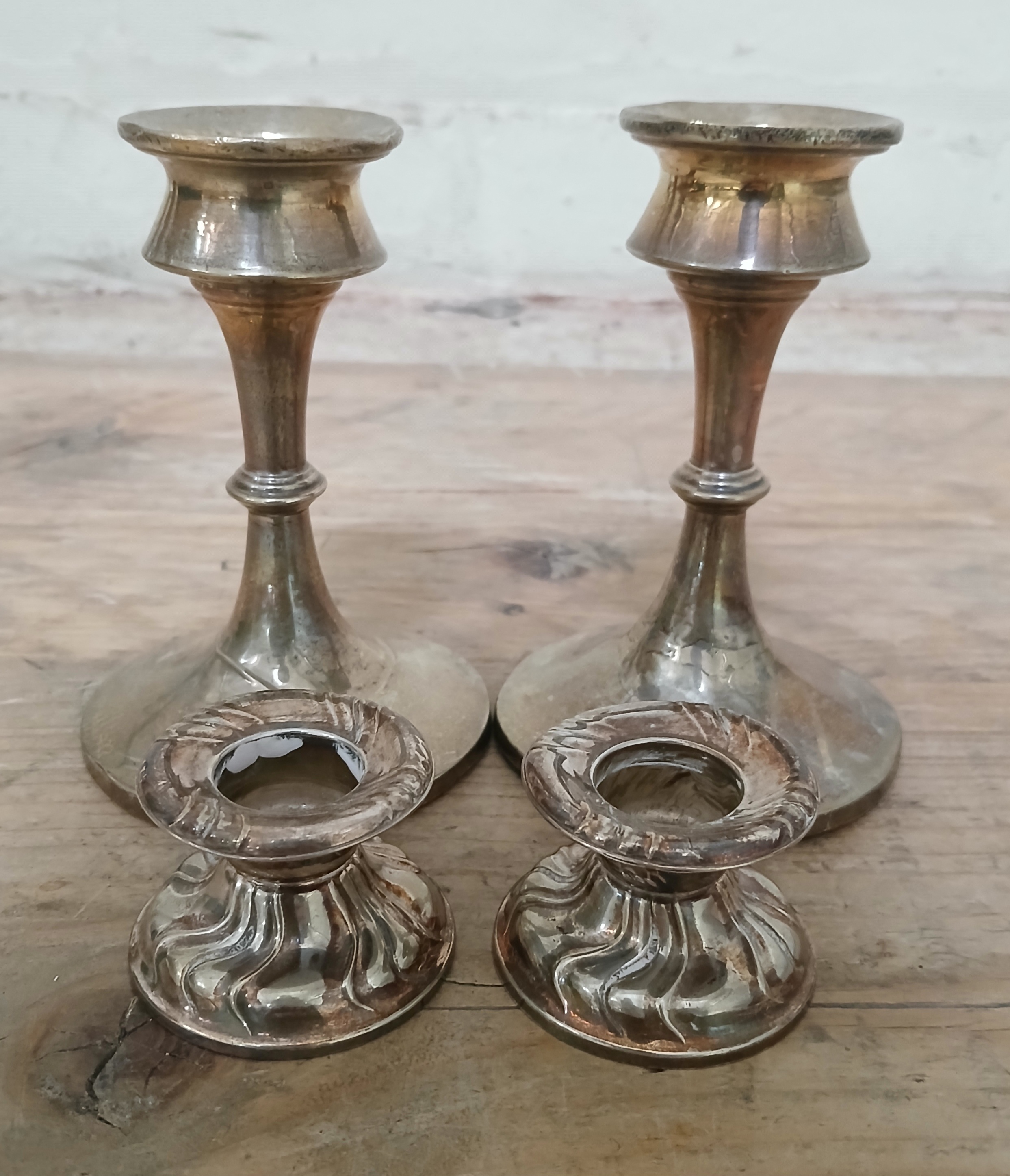 A pair of hallmarked silver (filled) candlesticks, height 12cm, & a pair of German silver
