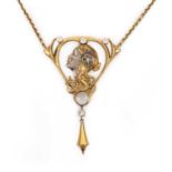 A gold, moonstone and diamond pendant necklace, designed in the Art Nouveau style, depicting a woman