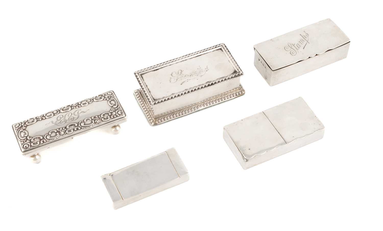 A collection of antique silver stamp boxes, comprising: one by The Alexander Clark Manufacturing Co,