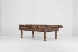 A carved wooden low table,