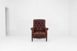 A buttoned-leather library armchair,