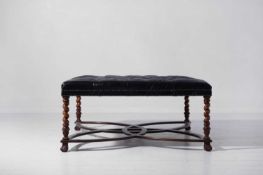 A large buttoned-leather stool,
