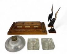An Edwardian oak clerk's or post office inkwell and three other glass inkwells, together with a pair