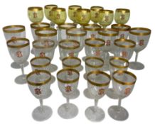 A large suite of thirty one late 19th century French glasses with gilded rims and enamelled monogram