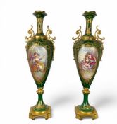 A pair of late 19th century French green and gilt decorated Sevres style slender vases