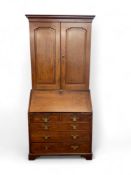 A George III oak bureau cabinet