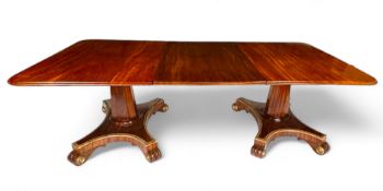 An unusual Regency twin pedestal mahogany and parcel gilt dining table