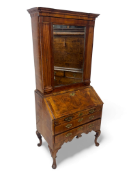 An unusual George II figured walnut, crossbanded and featherbanded bureau cabinet