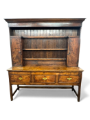 A late 18th century elm high dresser