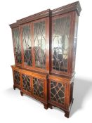 An Edwardian George III style mahogany and tulipwood banded breakfront library bookcase
