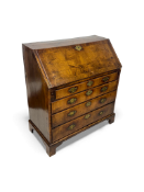 A George II walnut, crossbanded and featherbanded bureau