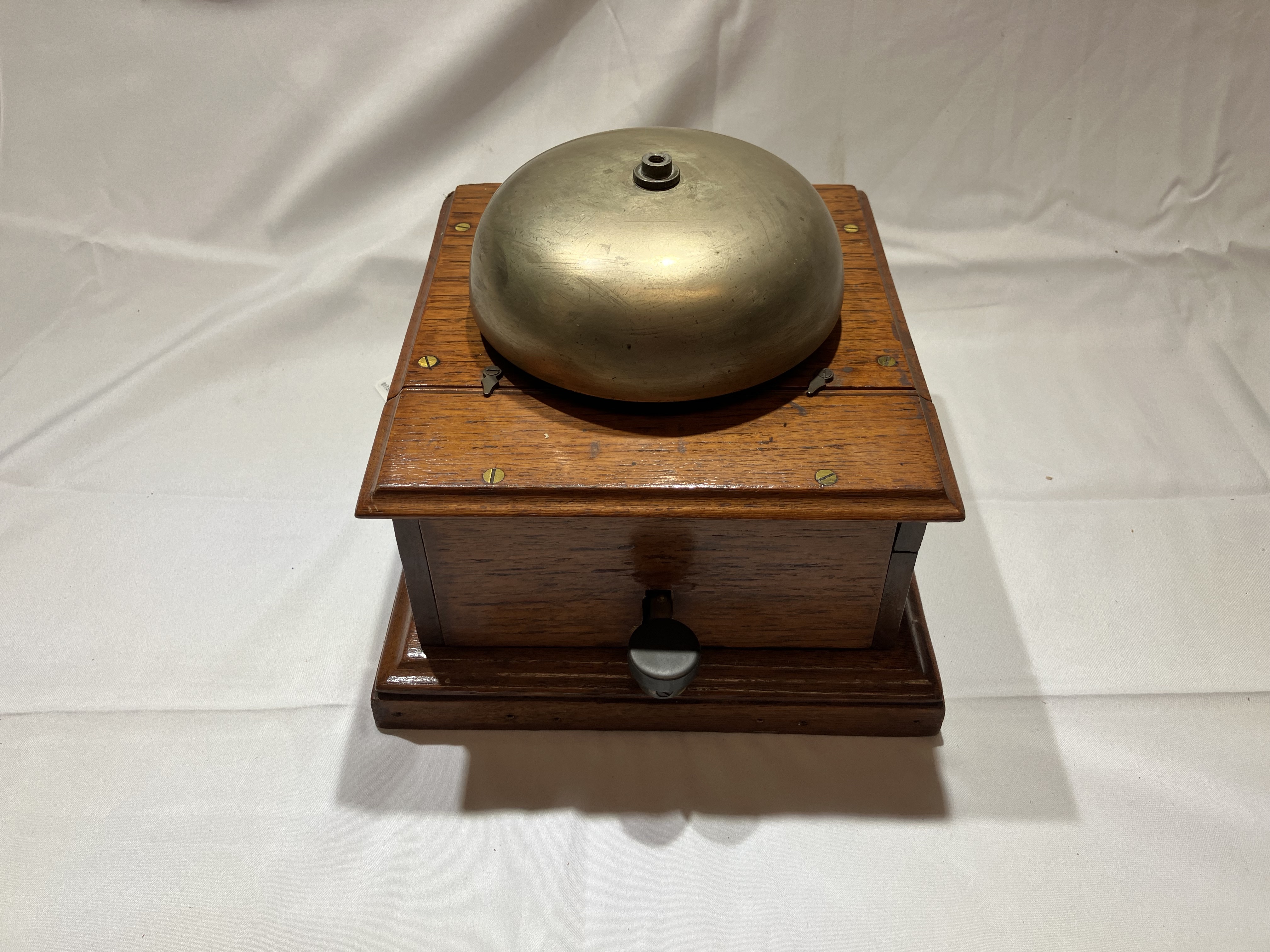 Block bell in a wooden case. There are no identifying markings.