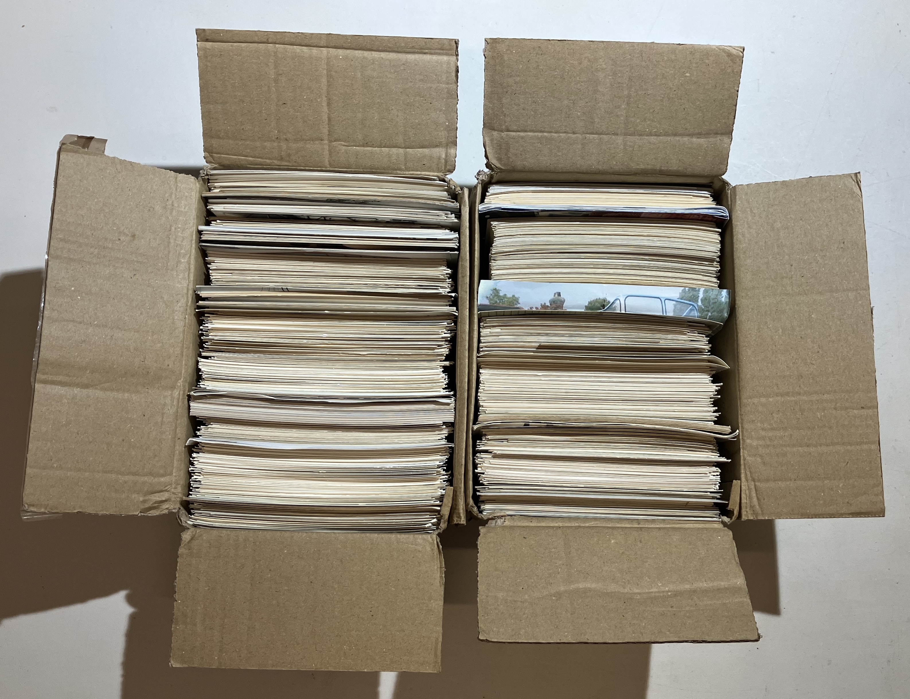 Estimated 1200 photographs that are a mix of postcard size black and white and 6x4 colour photos.