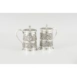 A pair of silver tankards with covers