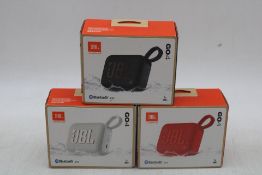 Three JBL Harman Go4 Speaker, 1x Black, 1x Red, 1x White